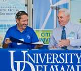 D Provost Domenico Grasso (left) with Patrick E. McCullar, president and CEO of the Delaware Municipal Electric Corporation, which will buy renewable energy credits generated by the University's wind turbine.